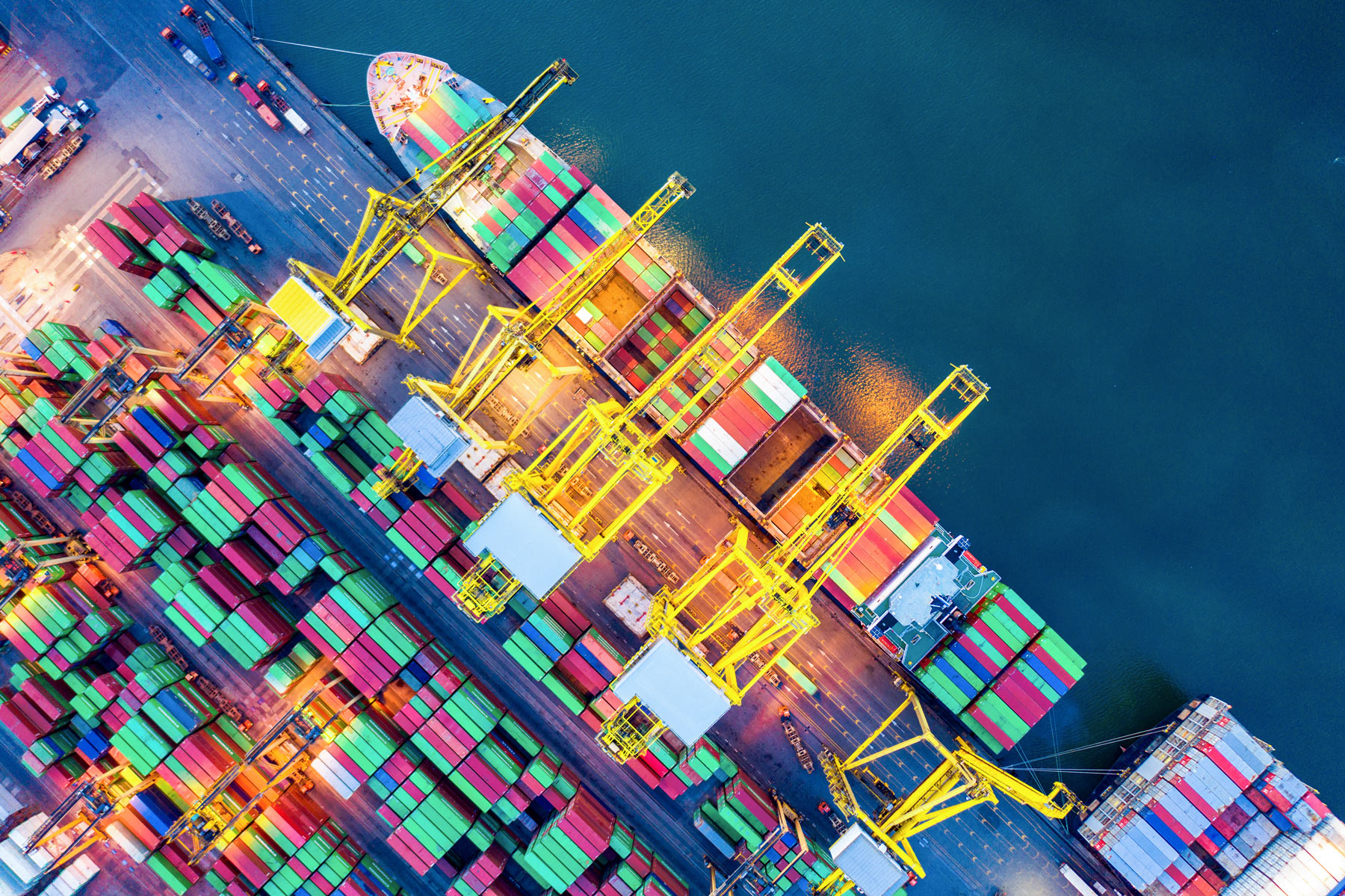Aerial view of container port with cargo ships and shipping containers