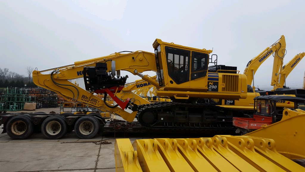 Heavy excavator loaded on a lowboy open-deck trailer