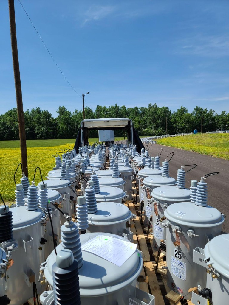 Industrial transformers secured on an open-deck trailer
